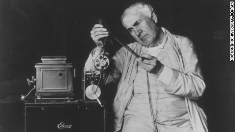 circa 1900:  American inventor Thomas Alva Edison (1847 - 1931) examining motion picture film threaded through one of his film projectors.  (Photo by )