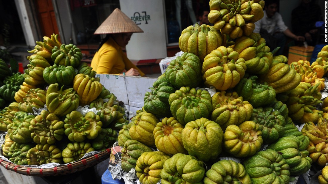 A woman sells &quot;Buddha hand&quot; fruits for Tet, or Vietnamese Lunar New Year, in downtown Hanoi, Vietnam, on February 12.