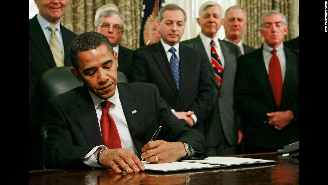 As retired military officers stand behind him, Obama signs an executive order to close down the detention center at Guantanamo Bay, Cuba, in January 2009.