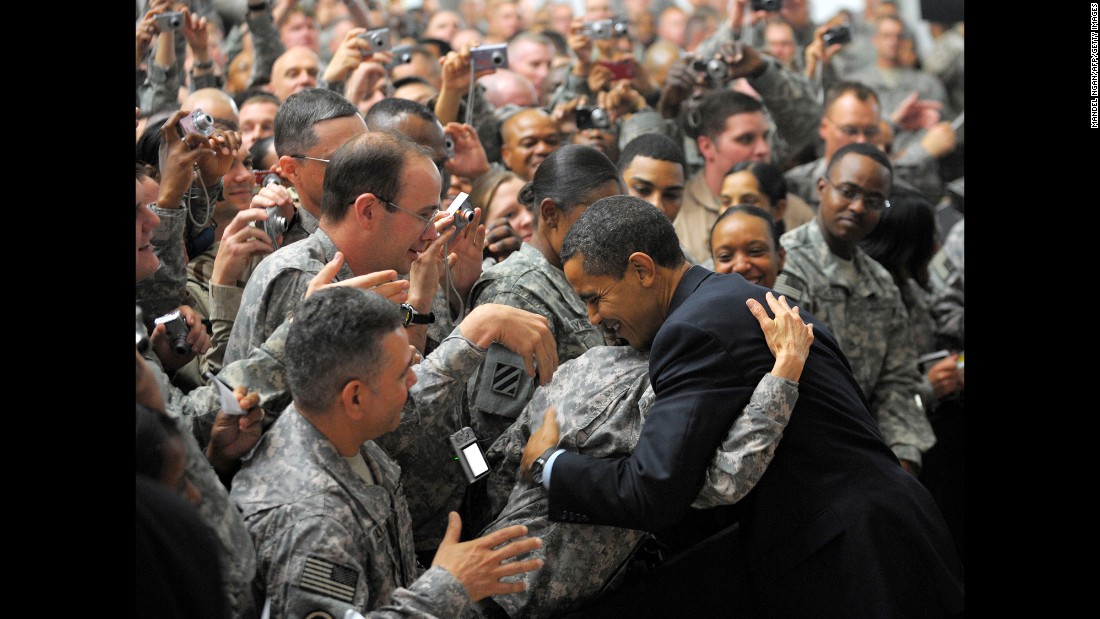 A soldier hugs Obama during his surprise visit to Camp Victory just outside Baghdad, Iraq, in April 2009. 