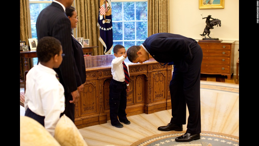 Obama bends over so the son of a White House staff member can pat his head during a visit to the Oval Office in May 2009. The boy &lt;a href=&quot;http://newsroom.blogs.cnn.com/2009/05/15/hair-apparent/&quot; target=&quot;_blank&quot;&gt;wanted to know &lt;/a&gt;if Obama&#39;s hair felt like his.
