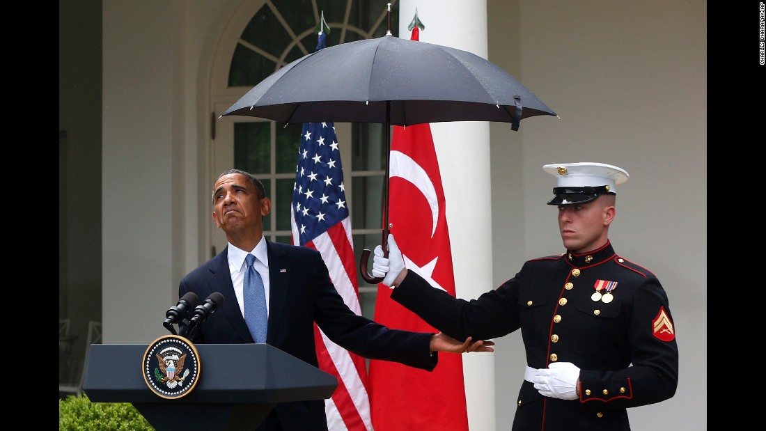 Obama adjusts an umbrella held by a Marine during a White House news conference with Turkish Prime Minister Recep Tayyip Erdogan in May 2013.