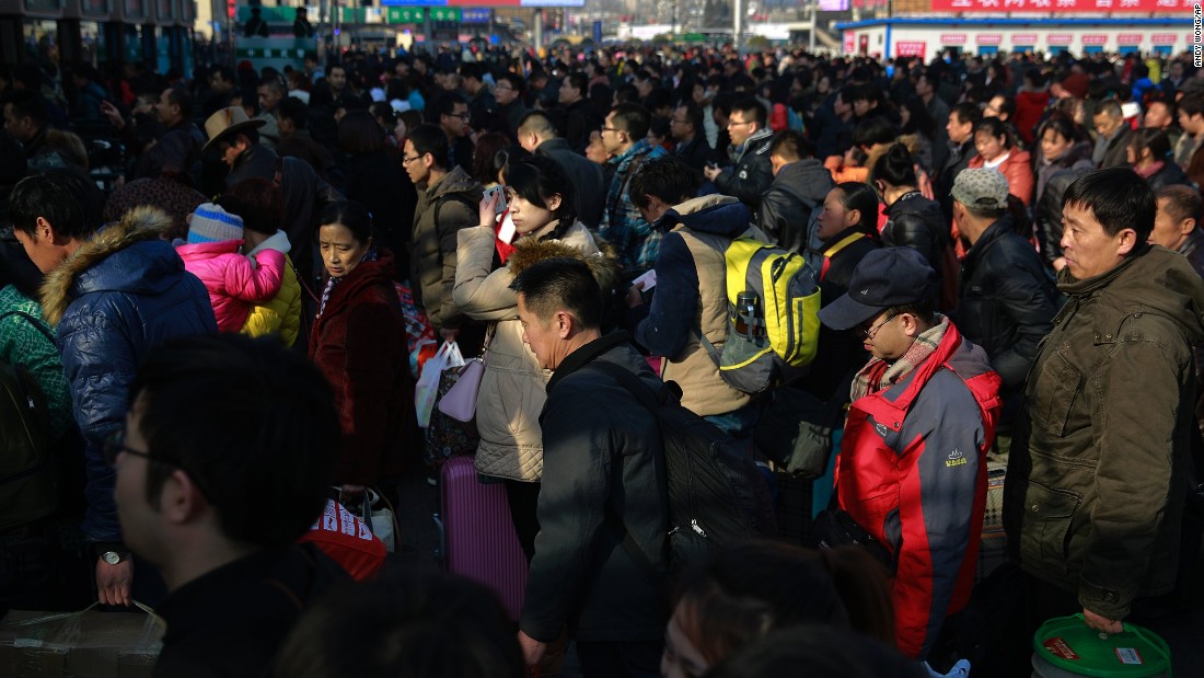 Chinese travelers queue up at the main entrance of the Beijing railway station in Beijing on Friday, February 13. Millions of Chinese were to travel to their hometowns to celebrate the Lunar New Year on February 19, marking the Year of the Sheep.