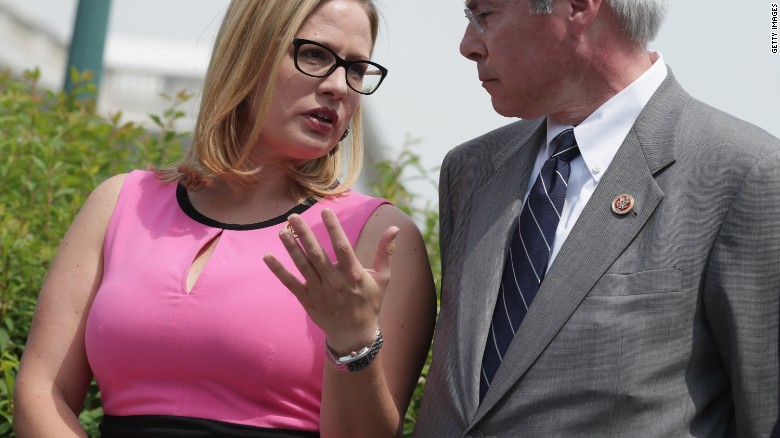 Then-Rep. Kyrsten Sinema and Rep. John Barrow, at left, are seen outside the U.S. Capitol in May 2014 in Washington, DC. 