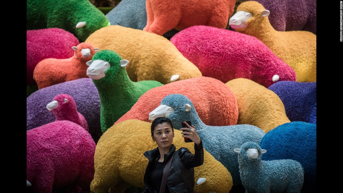 A woman takes a selfie in front of an art installation set up for Lunar New Year celebrations in a Hong Kong shopping mall on February 18.