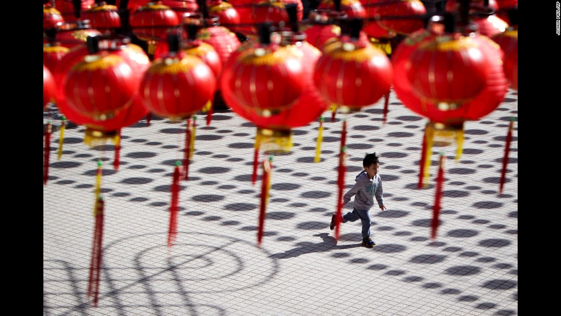 A boy runs through a temple with Chinese lantern decorations in Kuala Lumpur, Malaysia, on Tuesday, February 17.