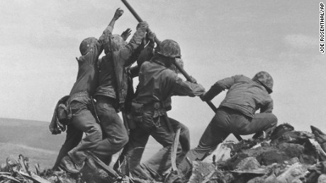 U.S. Marines of the 28th Regiment, 5th Division, raise the American flag atop Mt. Suribachi, Iwo Jima, on Feb. 23, 1945. Strategically located only 660 miles from Tokyo, the Pacific island became the site of one of the bloodiest, most famous battles of World War II against Japan. 