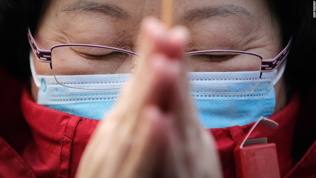 A woman prays in Beijing on February 19.