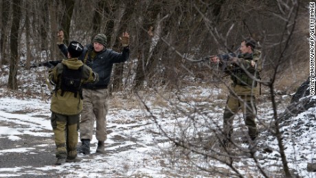 Two pro-Russian seperatists stop a man in the eastern Ukrainian city of Uglegorsk in 2015. 