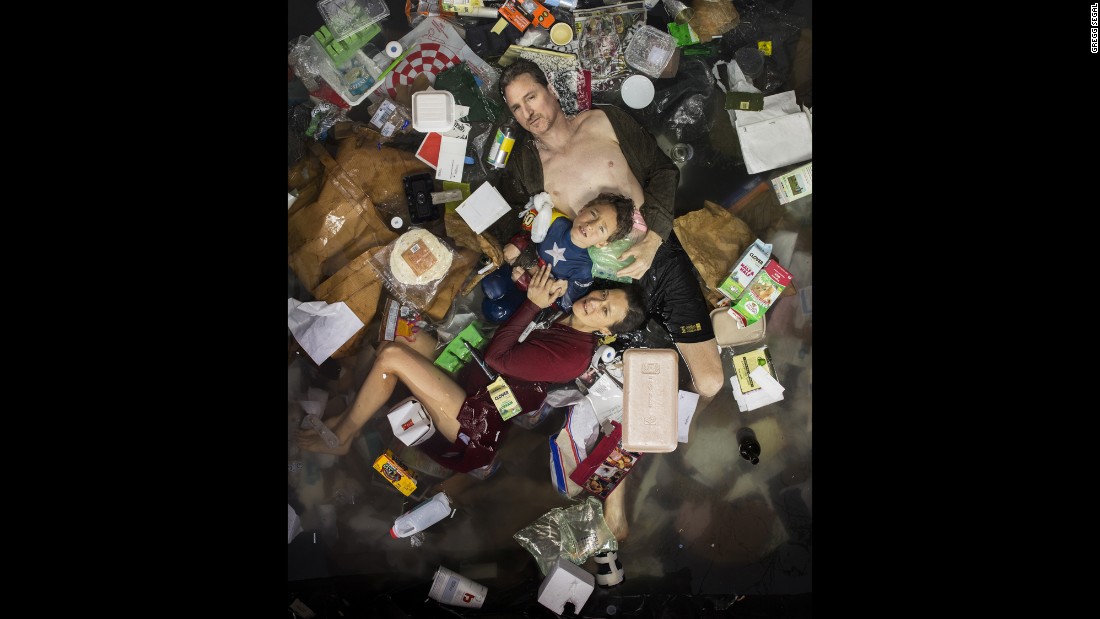 Photographer Gregg Segal gives himself a reality check by posing with one week of his family&#39;s trash.