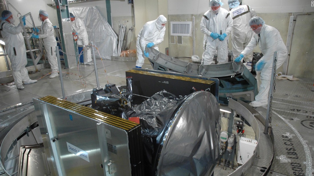 Workers at Cape Canaveral prepare Dawn for launch by removing its transportation canister.  Dawn was then mated with a Delta II rocket.