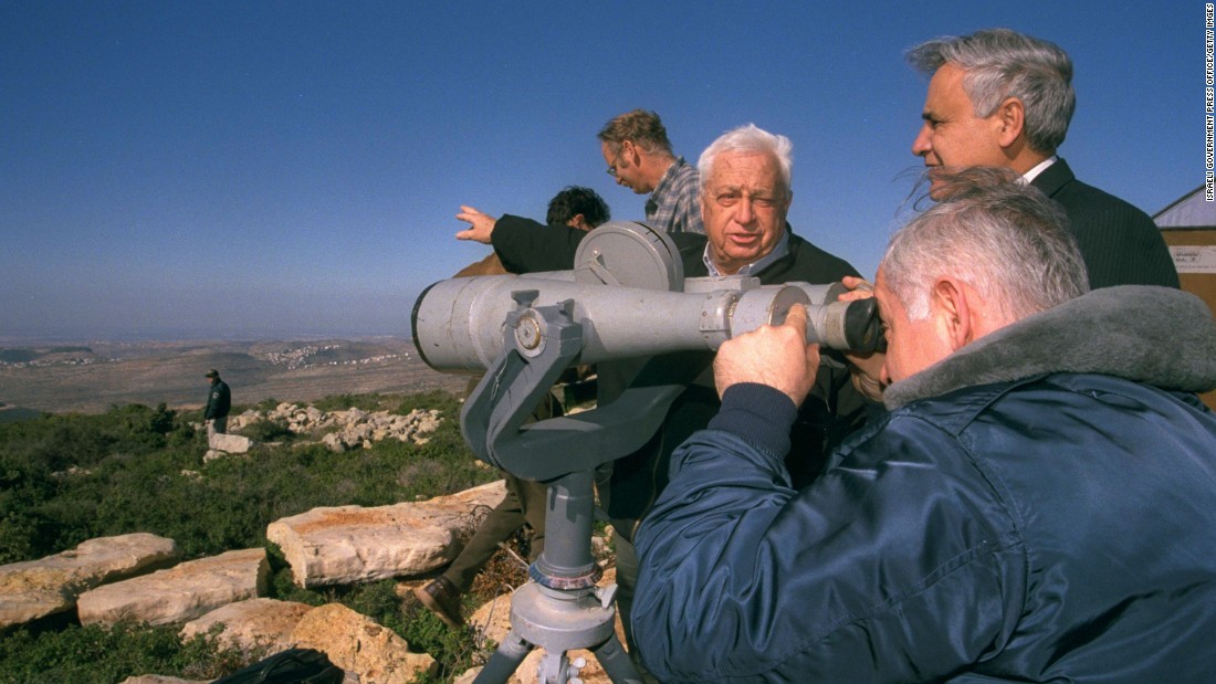Netanyahu looks through binoculars as he and the Israeli Cabinet tour the West Bank in December 1997.
