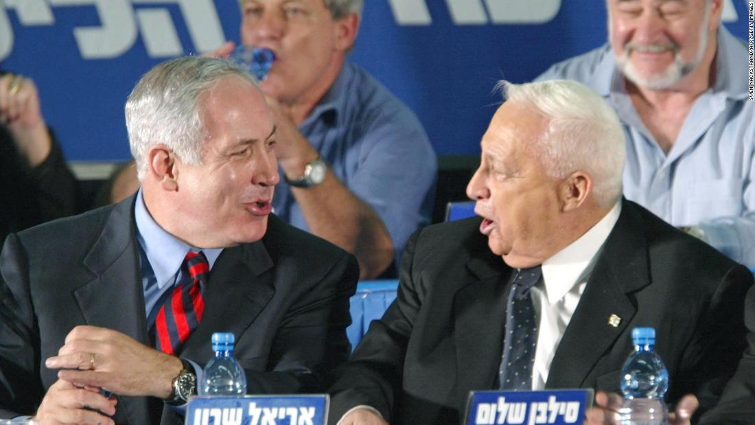 Netanyahu, as Israel&#39;s foreign minister, laughs with Israeli Prime Minister Ariel Sharon at the start of a Likud convention in Tel Aviv, Israel, in November 2002.