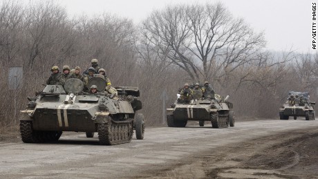 Ukrainian armored personnel carriers move cannons from their position near the eastern Ukrainian city of Artemivsk, in the Donetsk region on February 26, 2015. 