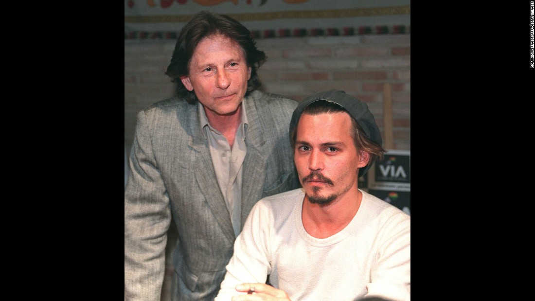 Polanski stands behind actor Johnny Depp during a press conference in Toledo, Spain, in 1998. The pair were shooting the film &quot;The Ninth Gate&quot; in Toledo. 
