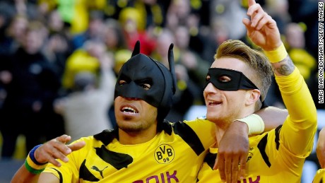 Aubameyang and Marco Reus celebrate as Batman and Robin after scoring against Schalke last year.