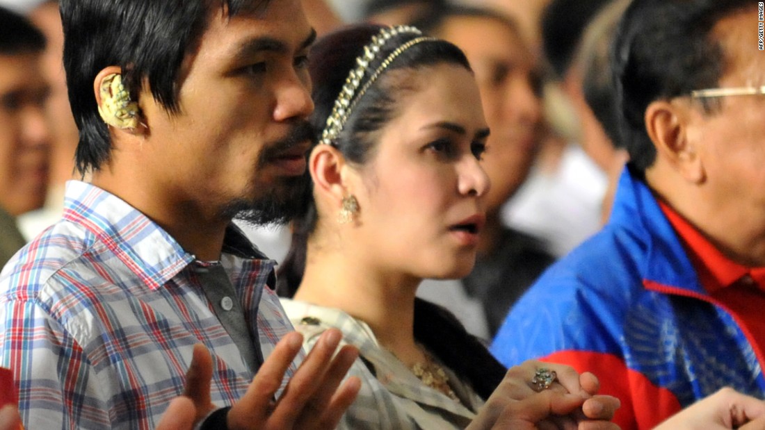 Most of Pacquiao&#39;s social media posts evoke his Christian faith and devotion to family. He is photographed with his wife Jinkee during mass in the Quiapo district of Manila on November 20, 2009. 