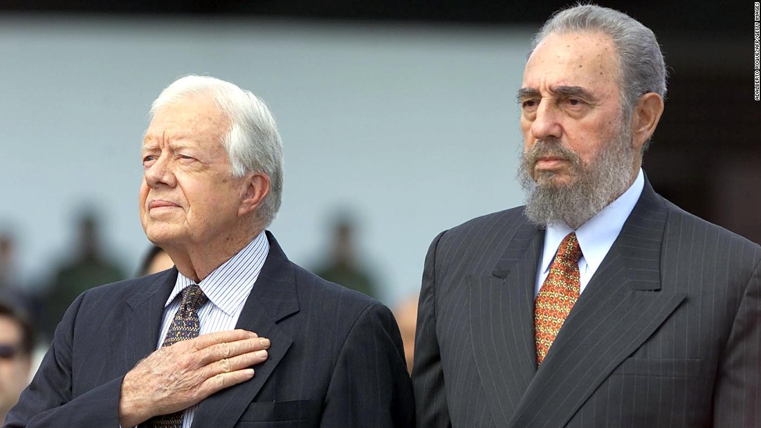 Castro and former US President Jimmy Carter listen to the US national anthem after Carter arrived in Havana for a visit in May 2002.