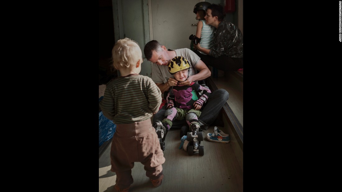 Anton Cervin, 40, puts a helmet on Marit, 4, while 1-year-old Pia watches. &quot;I think more about gender equality now that I have two little girls,&quot; he told Bavman.