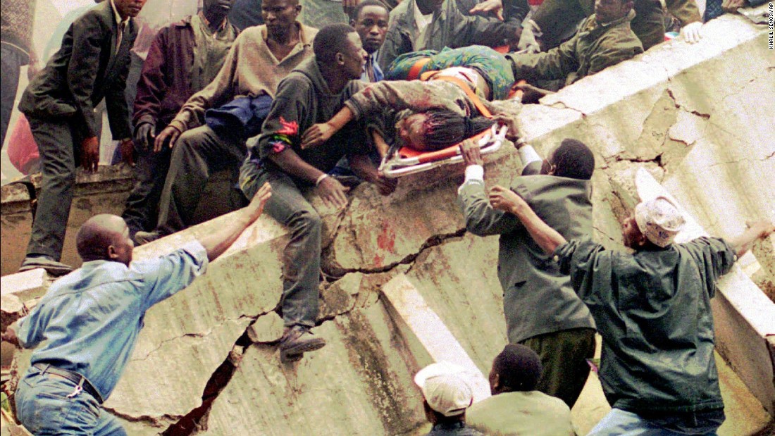 Rescue workers carry Susan Francisca Murianki, a U.S. Embassy office worker, over the rubble of a collapsed building next to the embassy in Nairobi, Kenya, on August 7, 1998.  A huge explosion tore through the embassy around the exact same time a bomb went off at the U.S. Embassy in Dar es Salaam, Tanzania.