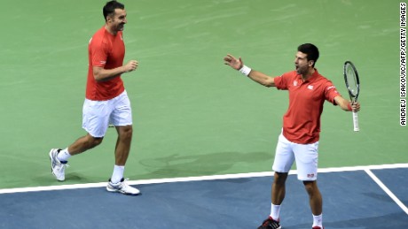 Novak Djokovic (right) and Nenad Zimonjic celebrate after gaining a point against Croatia&#39;s Marin Draganja and Franko Skugor during their Davis Cup match.