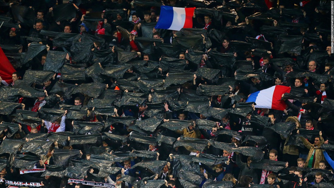 In Eastern France fans held aloft black flags in tribute to the victims at a match between Reims and Saint-Etienne at the Auguste Delaune stadium.
