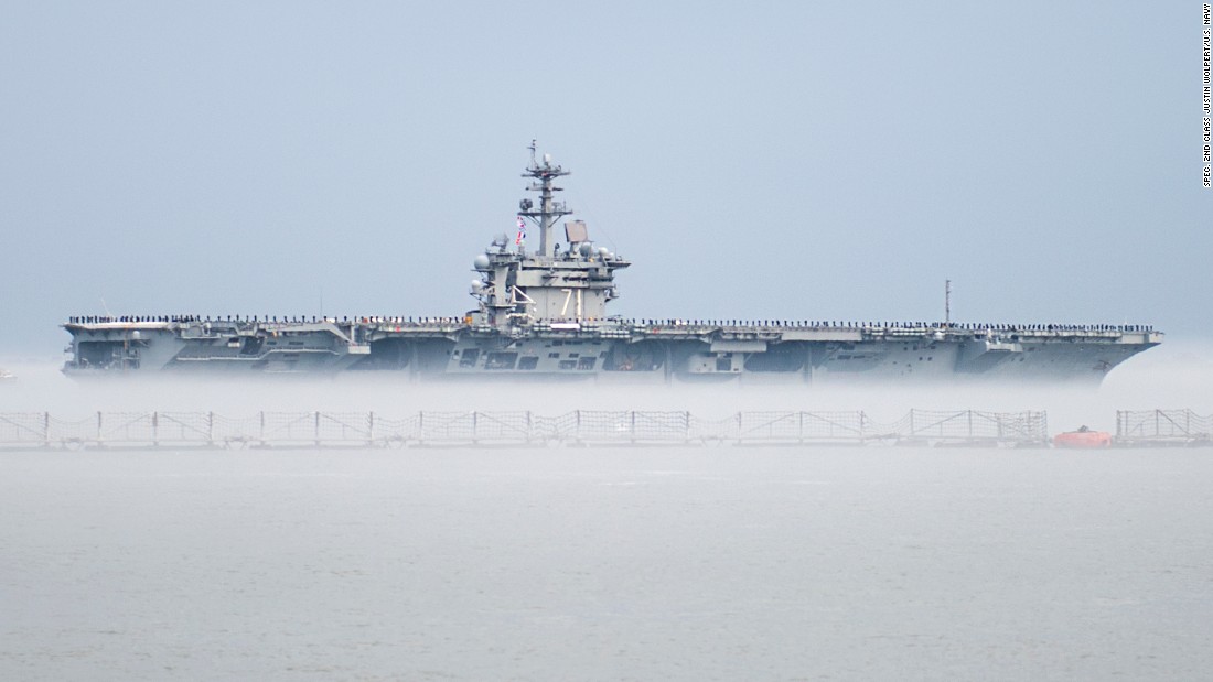 The aircraft carrier USS Theodore Roosevelt departs Naval Station Norfolk, Virginia, on Wednesday, March 11, for a scheduled deployment. The Nimitz-class carrier&#39;s departure was delayed for two days after marine growth clogged sea water intakes. Divers went into the 36-degree water to clean out the intakes and allow the ship to get under way. The cold water created a fog that made it seem the ship was in a cloud.