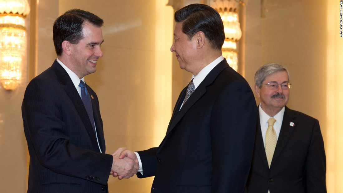 Scott Walker (left) shakes hands with Chinese President Xi Jinping (center) before a meeting as Iowa Governor Terry Branstad (right) looks on at the Great Hall of the People in Beijing on April 15, 2013.