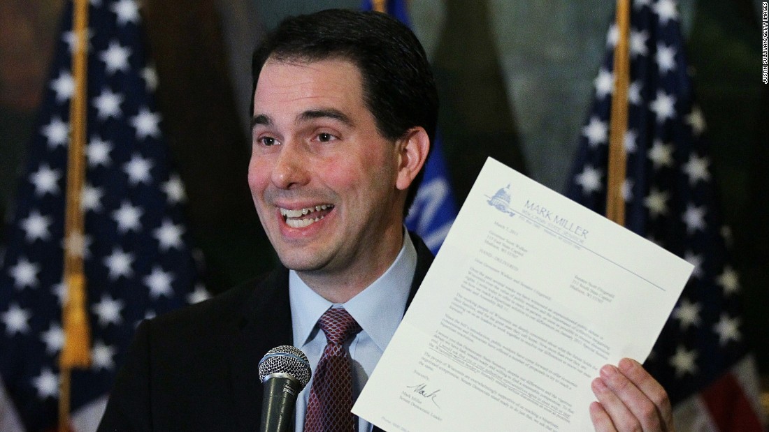 Walker holds a letter from democratic State Sen. Mark Miller, one of the fourteen Wisconsin state senators who fled the state over two weeks ago, during a press conference on March 7, 2011, in Madison, Wisconsin.
