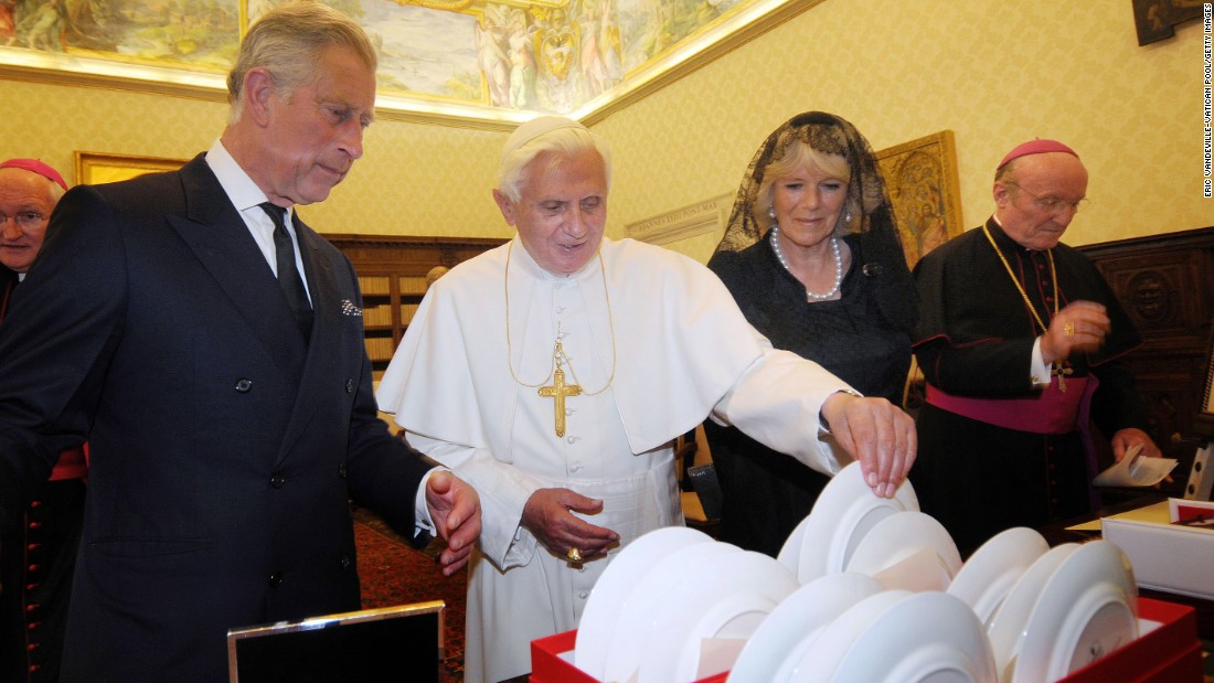 Pope Benedict XVI exchanges gifts with Charles and Camilla as they meet in the Pope&#39;s private library at the Vatican in April 2009. 