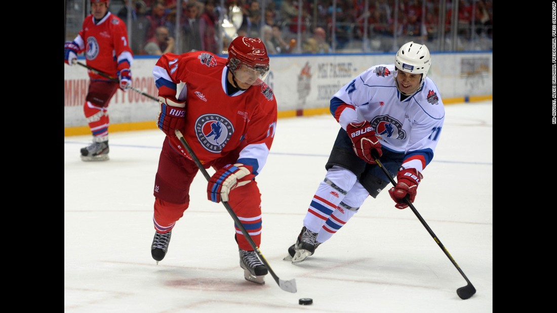 Putin controls the puck during an ice hockey game between Russian amateur players and ice hockey stars at a festival in Sochi, Russia, in May 2014.