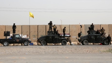Iraqi security forces and allied Shiite militiamen gather at the front line in Tikrit, Iraq, on Friday, March 13.