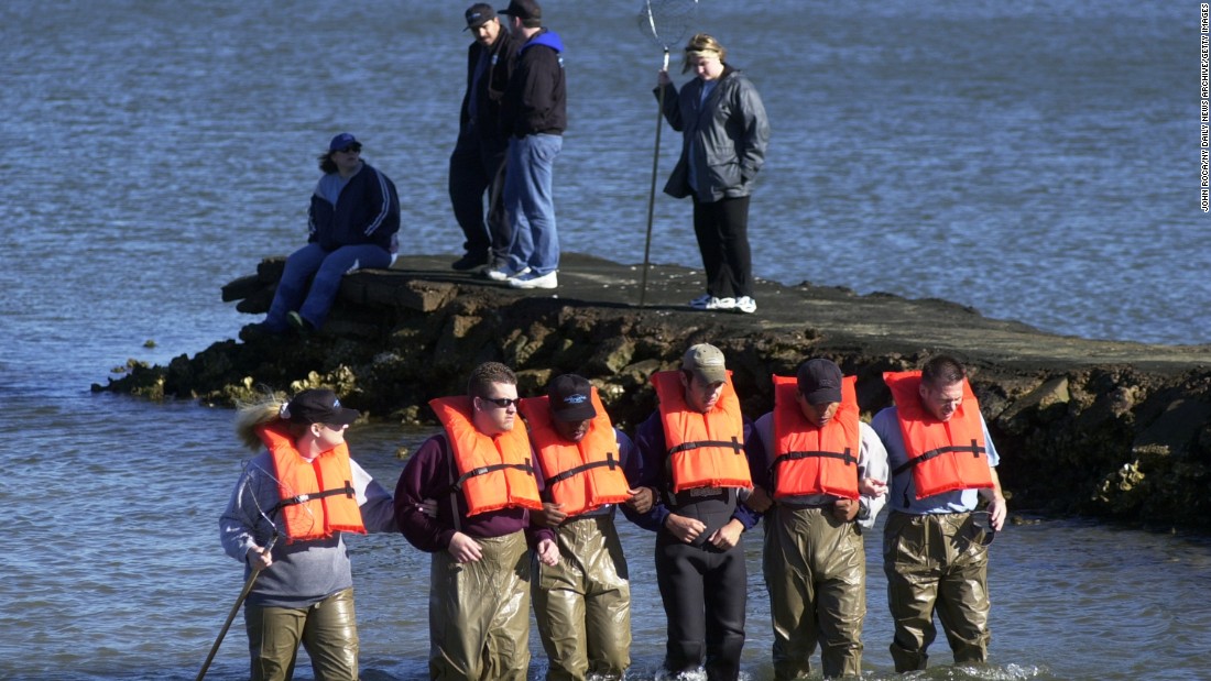 Private detectives comb a portion of Galveston Bay in search of Morris Black&#39;s remains in February 2002.