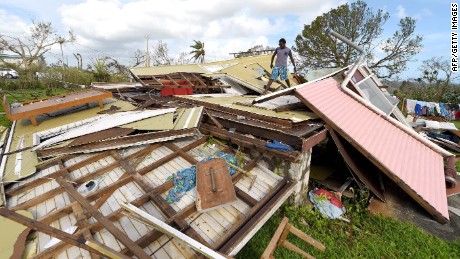 In this photo taken on March 16, 2015 a man looks through the ruins of his home in Vanuatu&#39;s capital Port Villa after Cyclone Pam ripped through the island nation. The UN said on March 17, 2015 that twenty-four people have been killed by Cyclone Pam, as the Pacific nation&#39;s president pleaded for help to rebuild the archipelago&#39;s &quot;completely destroyed&quot; infrastructure. AFP PHOTO / POOL / DAVE HUNTDAVE HUNT/AFP/Getty Images