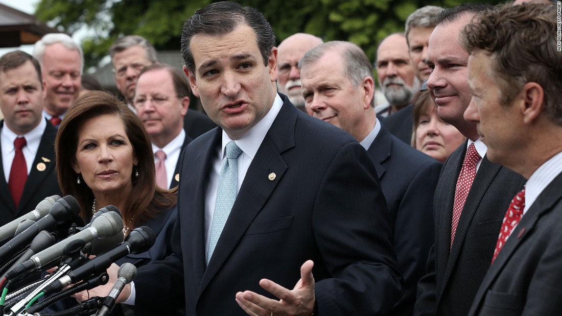 Cruz speaks as then-Rep. Michele Bachmann (left), Sen. Mike Lee (second right) and Sen. Rand Paul (right) listen during a news conference May 16, 2013, on Capitol Hill.