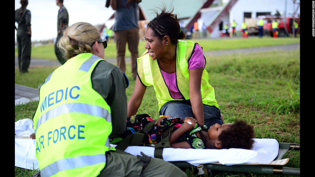 Australian doctors help a young girl on the Vanuatu island of Tanna on Wednesday, March 18.