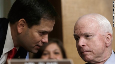 Sen. Marco Rubio (R-FL) (left) confers with Sen. John McCain (R-AZ) (right) as U.S. Ambassador to Syria Robert Ford testifies before the Senate Foreign Relations Committee October 31, 2013 in Washington, D.C.