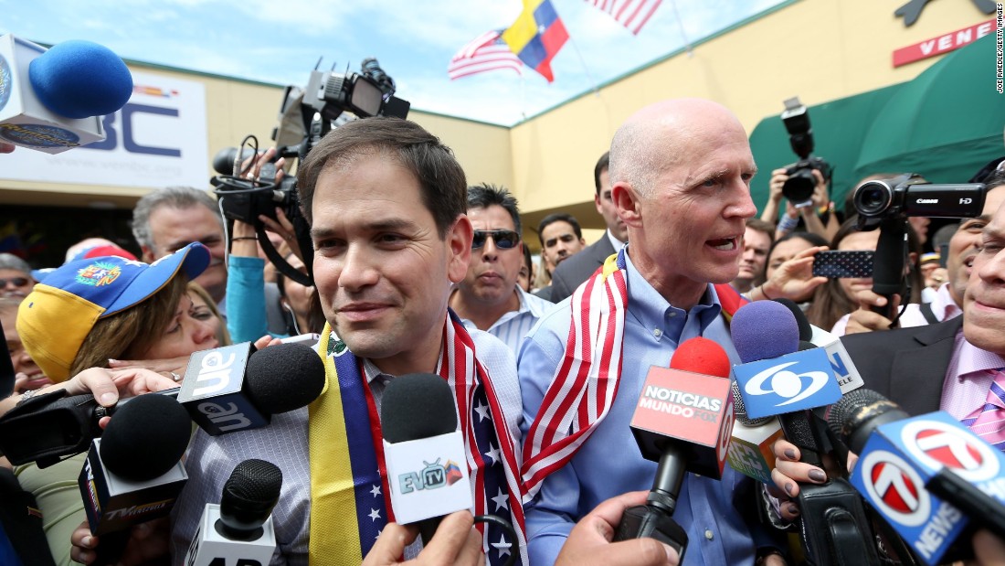 Rubio, left, and Florida Gov. Rick Scott speak to the media in Doral in February 2014.