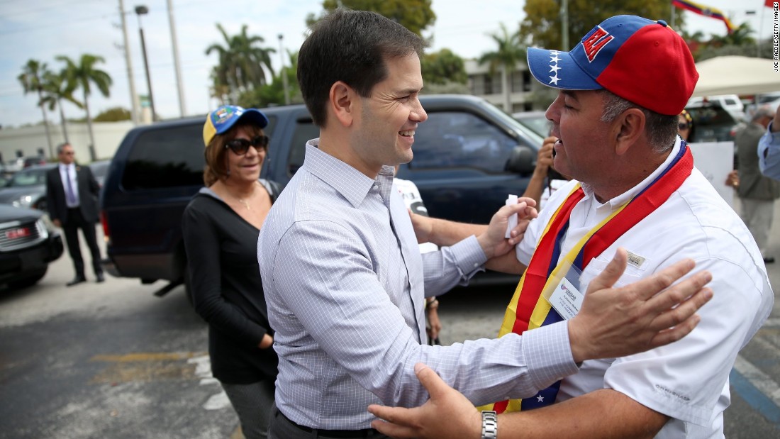 Rubio, left, is greeted as he arrives at a restaurant in Doral in February 2014.