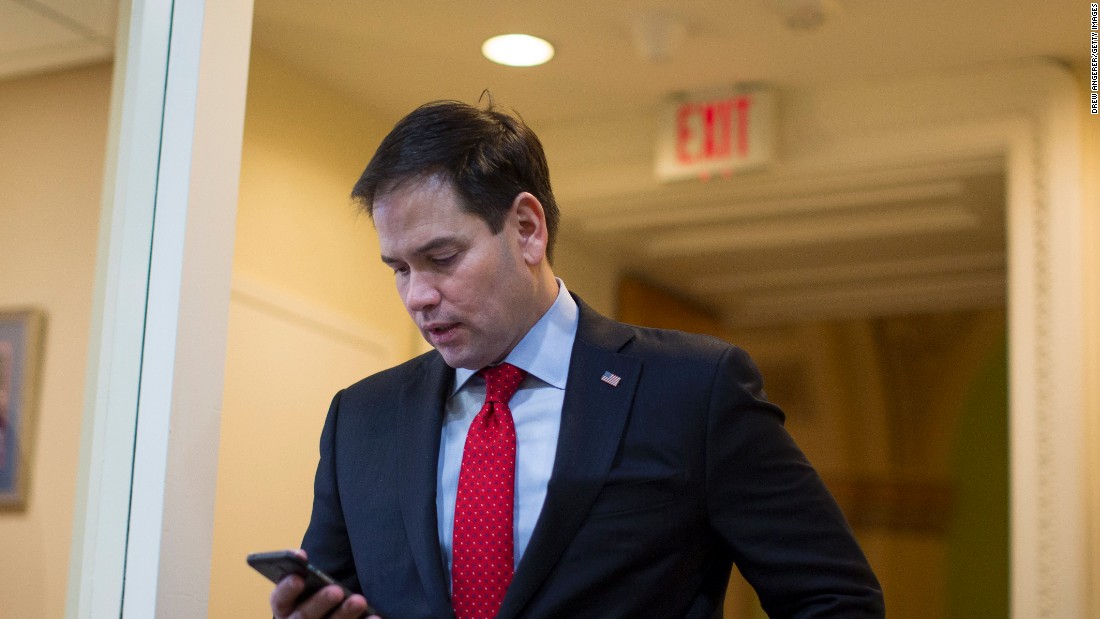 Rubio checks his phone in March as he arrives for a Capitol Hill news conference to introduce a proposal for an overhaul of the tax code.