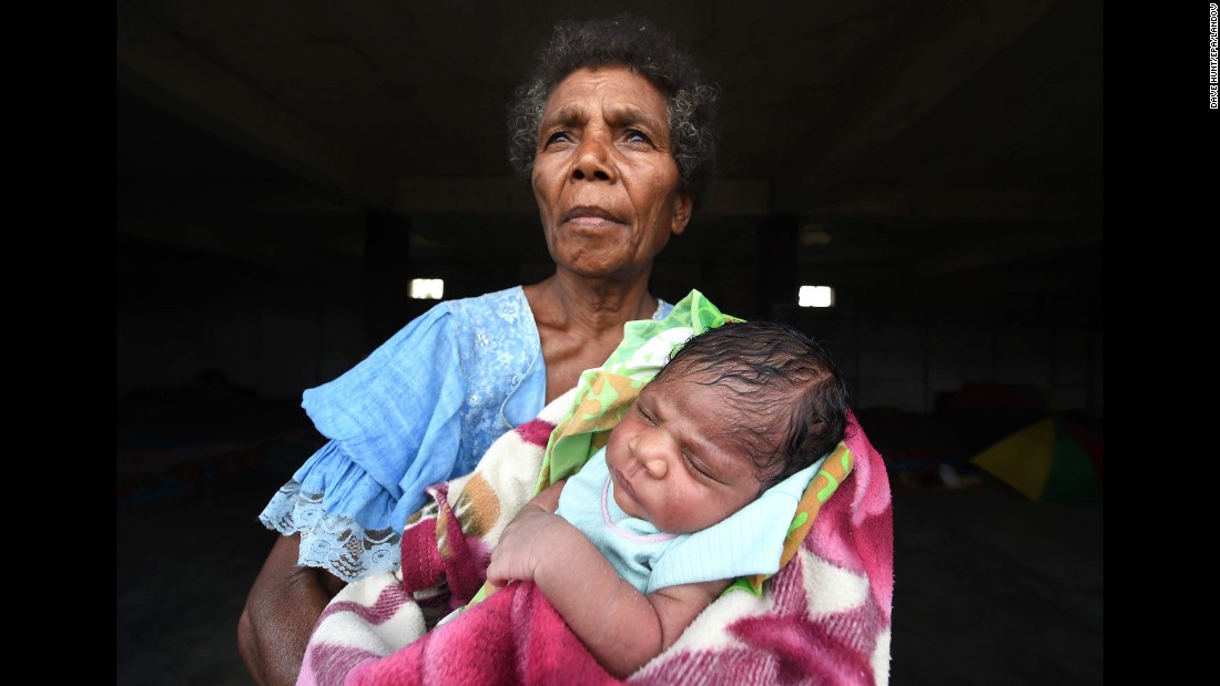 Mercy Watskal holds her week-old granddaughter, Angelina, at the Enima Evacuation Center on Tanna Island on March 19.