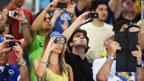 CUIABA, BRAZIL - JUNE 21:  Fans look on with electronic devices during the 2014 FIFA World Cup Group F match between Nigeria and Bosnia-Herzegovina at Arena Pantanal on June 21, 2014 in Cuiaba, Brazil.  (Photo by Stu Forster/Getty Images)
