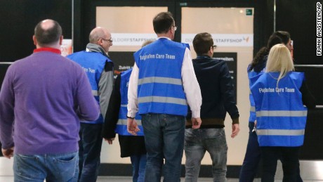 Airport staff in Duesseldorf escort people to a waiting area on March 24.