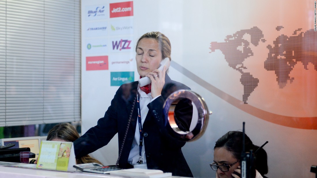 An employee of Swissport, the handling agent of Germanwings flights from Barcelona, speaks by phone at the Barcelona-El Prat Airport on March 24.