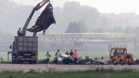 Workers remove wreckage of an MD-87 airliner that crashed at Linate Airport, near Milan, on October 8, 2001.