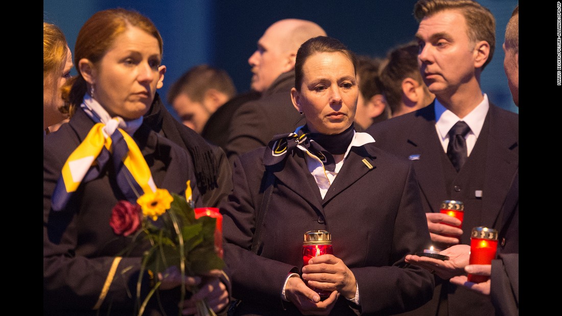 Staff members of Germanwings and Lufthansa stand in front of the Germanwings headquarters in Cologne, Germany, on March 24. They placed flowers and candles at the main entrance. Germanwings is a low-cost airline owned by the Lufthansa Group.