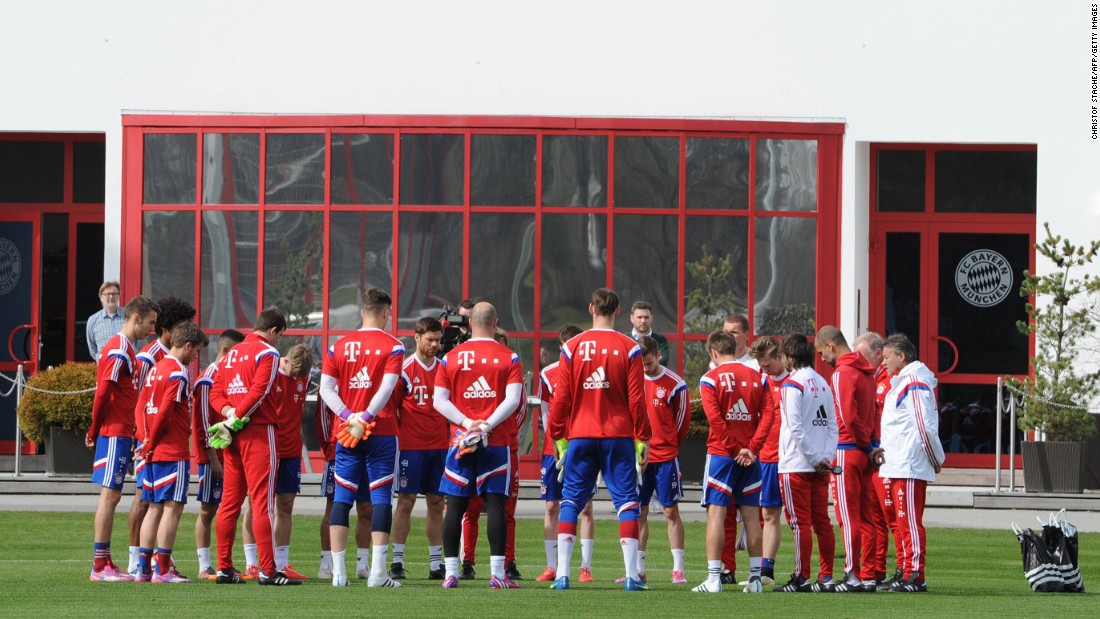 Members of the German soccer club Bayern Munich hold a moment of silence before their practice in Munich on March 25.