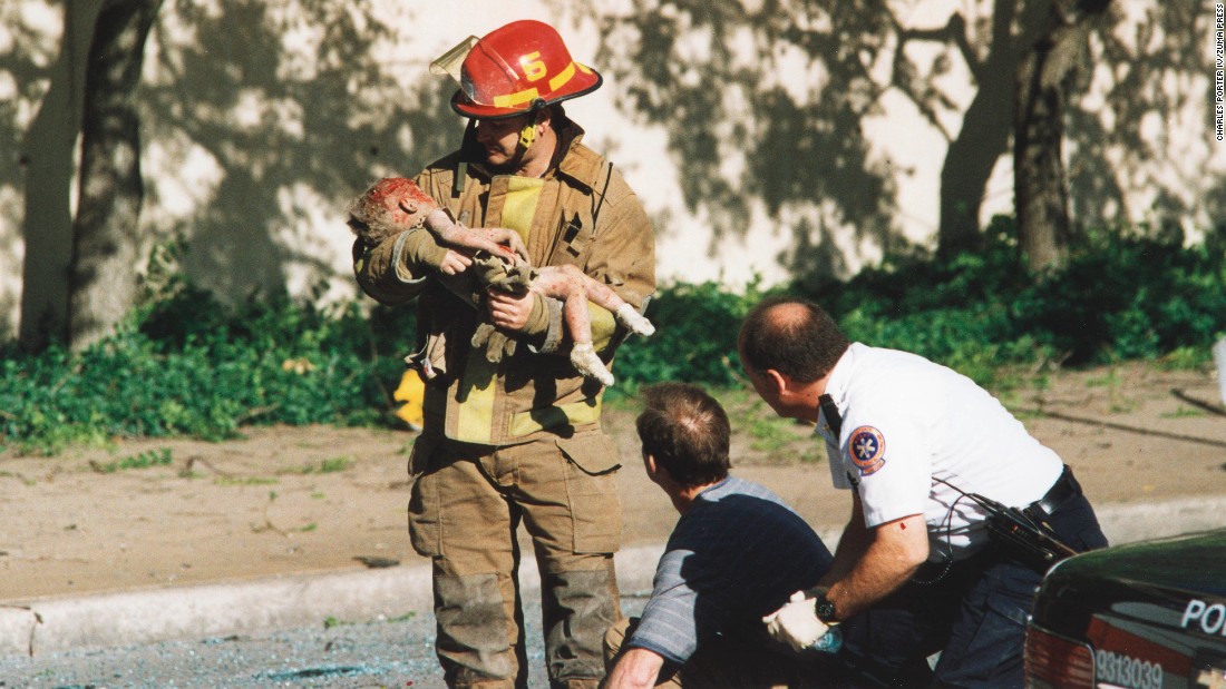 Oklahoma City firefighter Chris Fields holds a baby who was inside the Alfred P. Murrah Federal Building when it was hit by a truck bomb on April 19, 1995. The 1-year-old, Angel Baylee Almon, later died in the hospital. She was one of the 168 people killed in the terrorist attack. More than 500 people were injured.