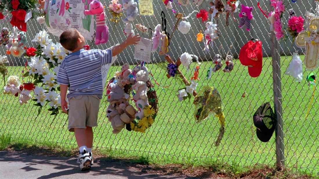 A boy visits the fence that surrounds the remains of the Federal Building in May 1997. It was later razed, and a park and memorial was built on the site.