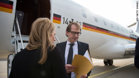 German Transport Minister Alexander Dobrindt (R) prepares to board a plane in Berlin to travel to the French Alpine region where a German passenger plane crashed, killing all 150 people tohgether with with the German foreign minister on March 24, 2015. The head of low-budget airline Germanwings said there were 144 passengers and six crew on the Airbus A320 that crashed in the French Alps en route to Duesseldorf from Barcelona. AFP PHOTO / DPA / OLIVER BERG +++ GERMANY OUT +++BERND VON JUTRCZENKA/AFP/Getty Images